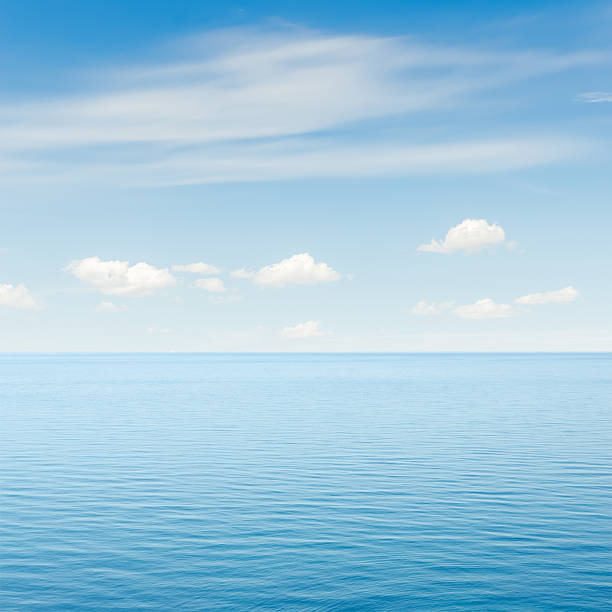 istock blue sea and sky with clouds over it 511060999