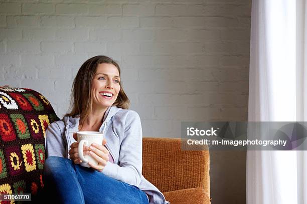 Smiling Woman Enjoying Cup Of Tea At Home Stock Photo - Download Image Now - Women, One Woman Only, Tea - Hot Drink