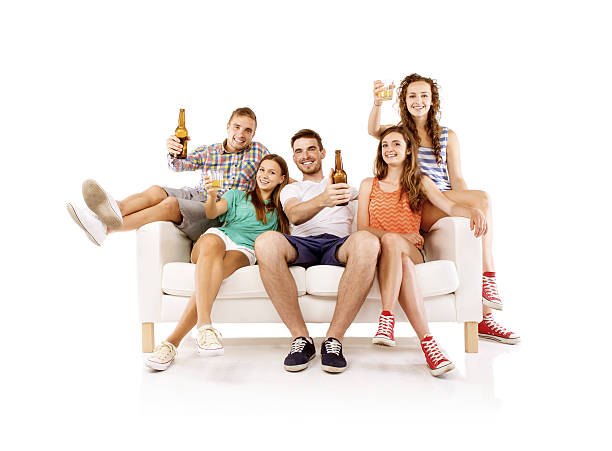 istock Group of young people with drinks on sofa 511061969