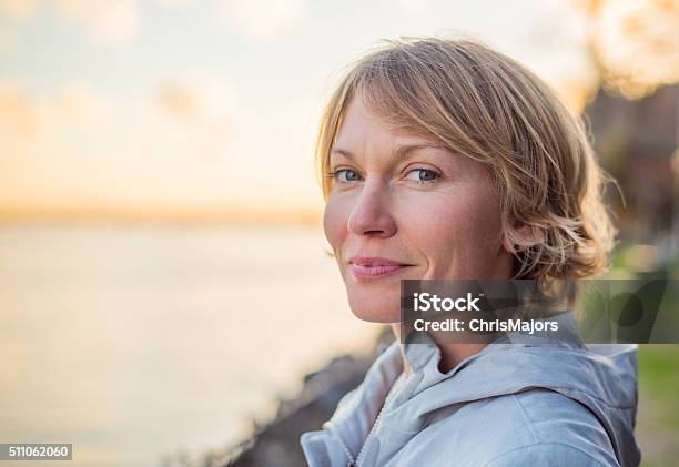 Mid 30s Woman With Strong Smile At Sunset Stock Photo - Download Image Now - Women, One Woman Only, Contented Emotion