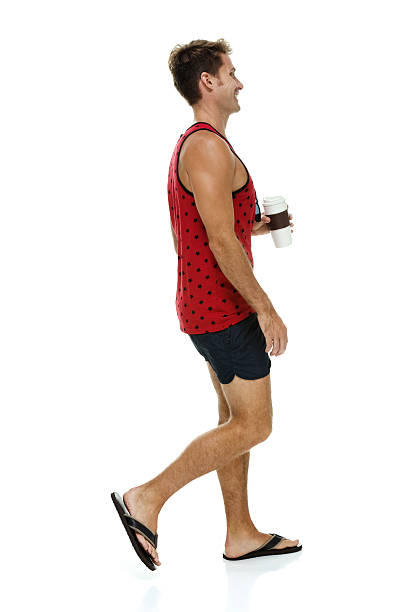 istock Smiling casual man holding coffee cup and walking 511062588