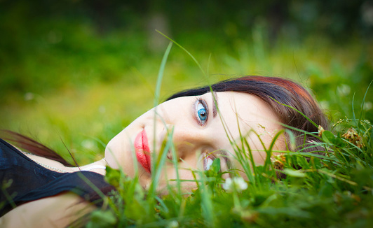 Portrait of a girl lying in the grass