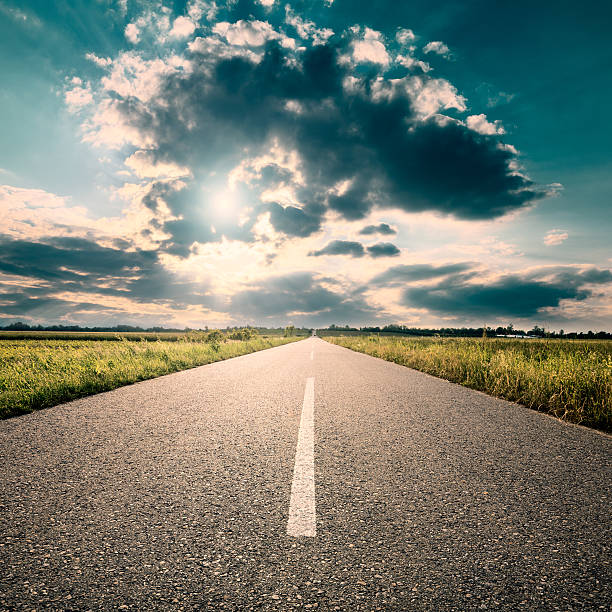 istock Driving on road towards the setting sun 511063211
