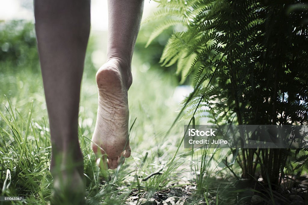 Barefoot Young woman walking Barefoot Stock Photo