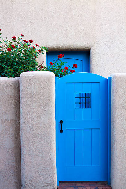 istock Santa Fe Style: Blue Door, Red Roses, Adobe Walls 511063573