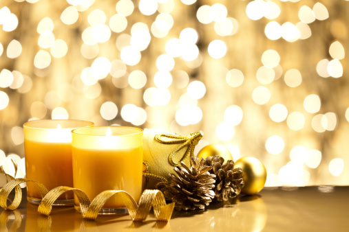Two Christmas Candles with Golden Decoration. Selective Focus