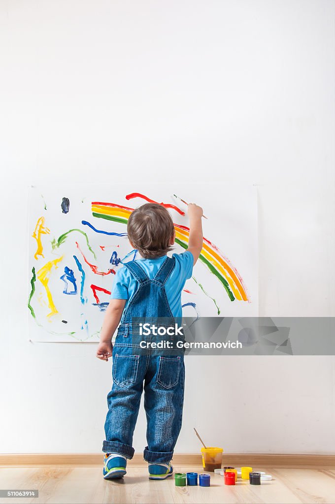 child draws ink on paper child draws colored paint spots on paper Child Stock Photo