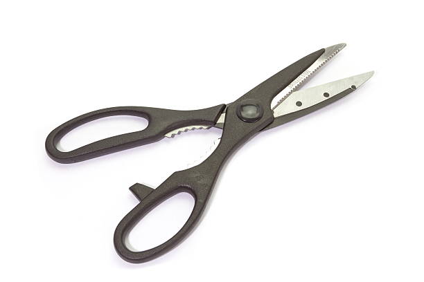 istock Close - up black metal scissor on white background 511064375
