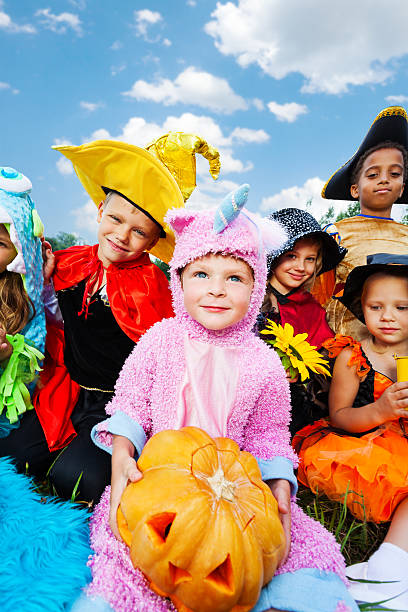 istock Boy holding Halloween pumpkin with his friends 511064515
