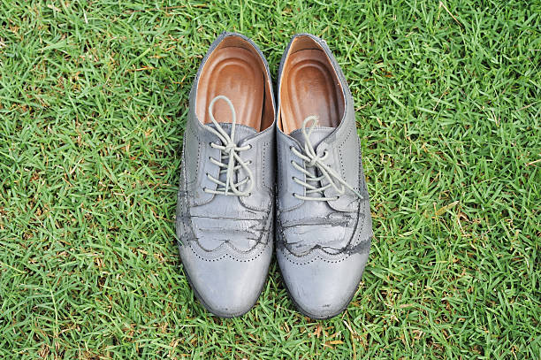 istock old grey shoes on lawn 511064712