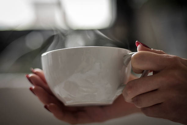 istock Women's hand holding a warm cup 511065068