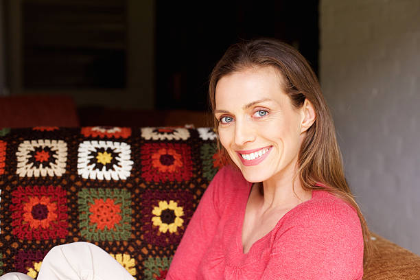istock Smiling woman sitting at home relaxing 511065130