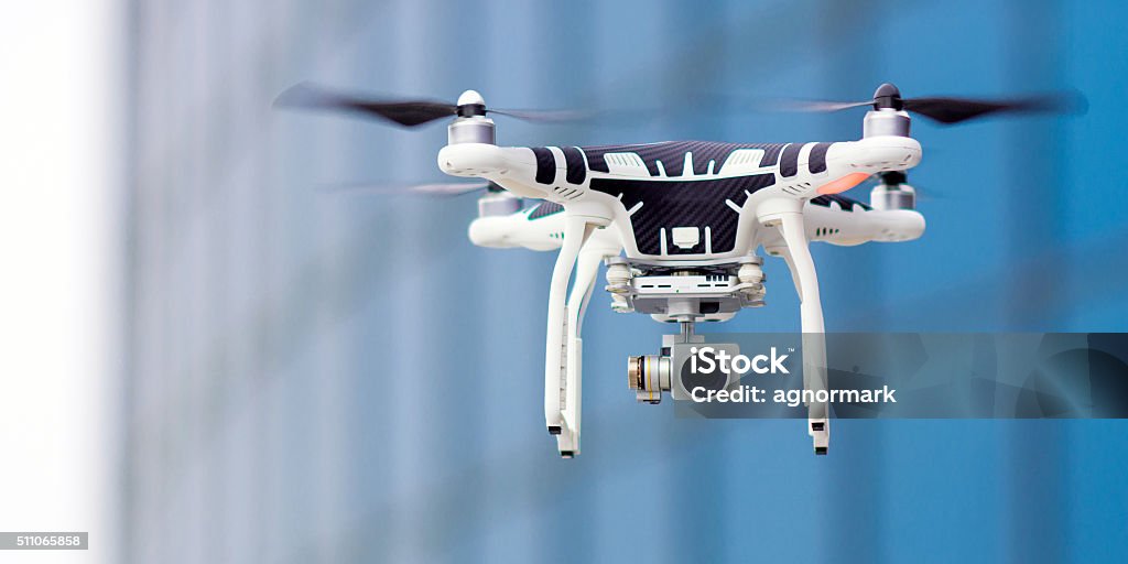 Hovering drone that takes pictures Hovering drone that takes pictures of city sights Drone Stock Photo