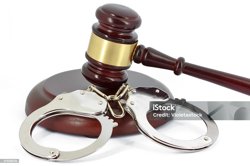 Handcuffs and gavel Arrest Stock Photo