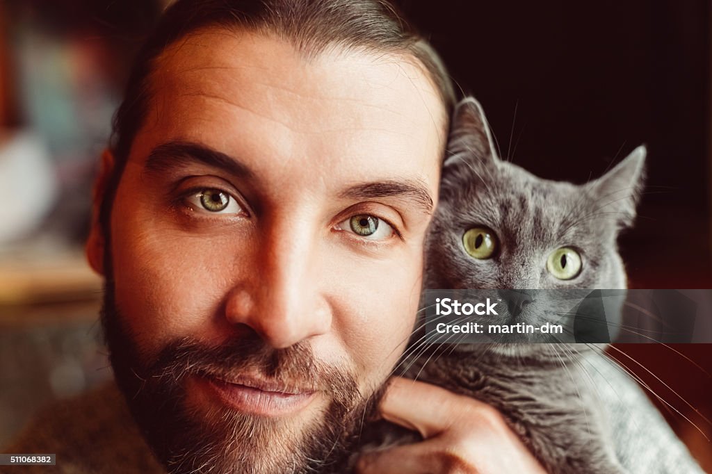 Man and cat taking selfie Mid adult man and cat looking at camera Domestic Cat Stock Photo