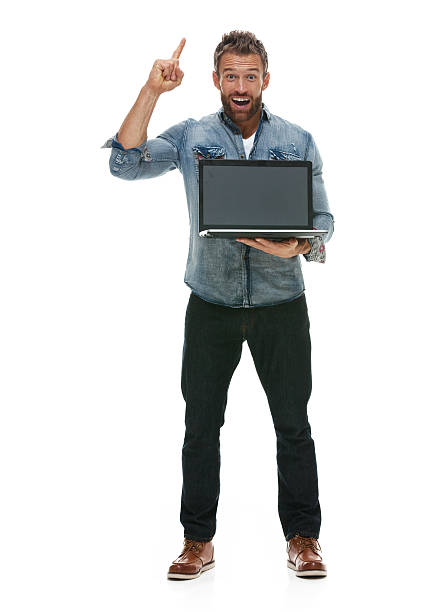 istock Smiling casual man holding laptop and pointing 511071156
