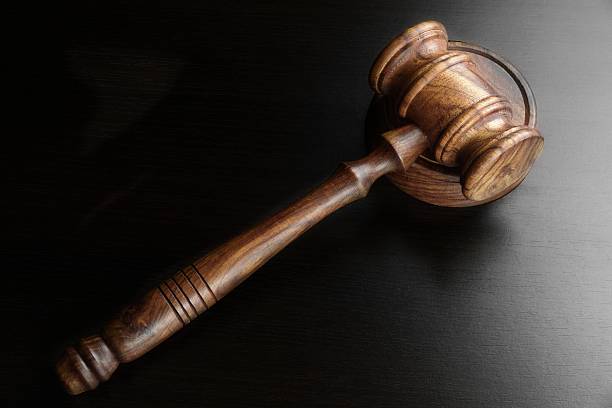 istock Judges Or Auctioneers Walnut Gavel On The Black Table 511073200