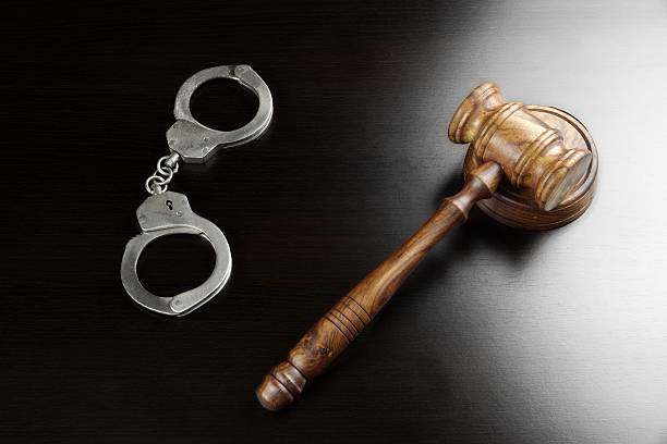 istock Real Judges Gavel And Handcuffs On The Black Table 511073262