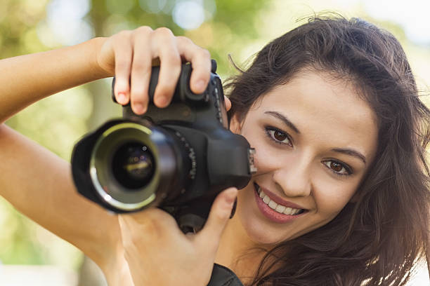 istock Gorgeous brunette woman holding her camera 511091717
