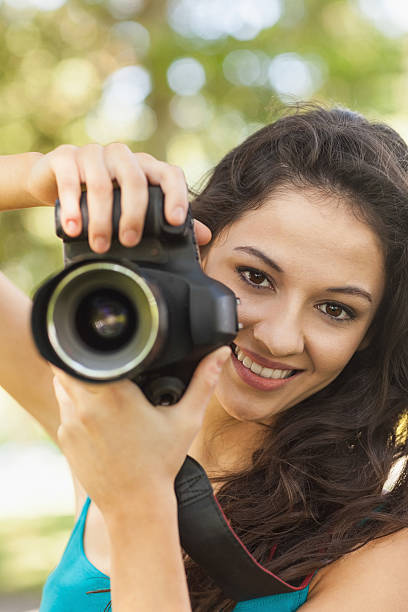 istock Happy attractive woman holding her camera 511091725