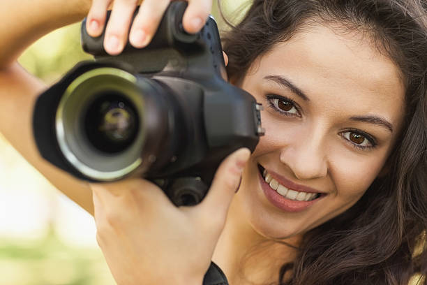 istock Gorgeous calm woman holding her camera 511091727