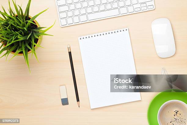 Office Table With Notepad Computer Coffee Cup And Flower Stock Photo - Download Image Now