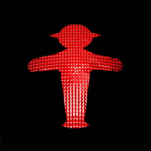 Red traffic light with the Ampelmann of East Germany, Berlin Berlin, Germany - August 8, 2014: CLose up of a red pedestrian traffic light with the Ampelmann of East Germany ampelmännchen photos stock pictures, royalty-free photos & images