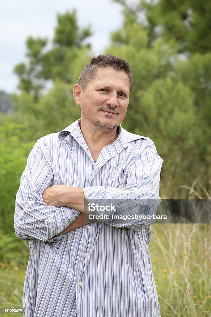 Senior Man Outdoors Portrait of a senior man outdoors with arms crossed. 60-64 Years Stock Photo