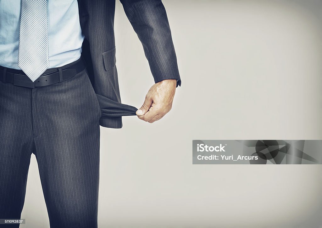 I'm drained financially Cropped image of an unrecognizable businessman pulling out his empty pocket Pocket Stock Photo