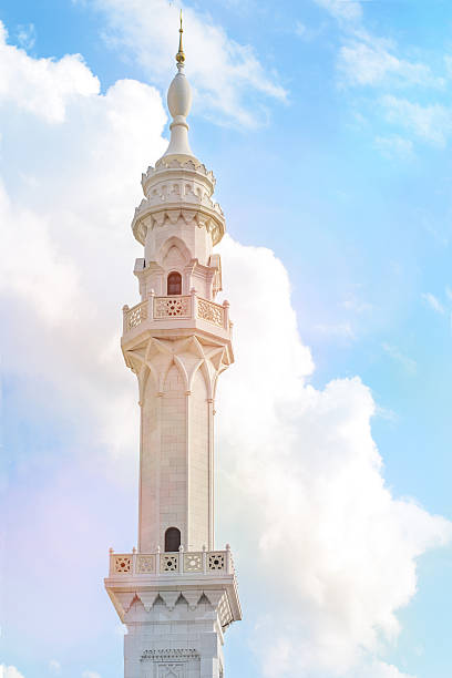 istock White mosque with a minaret on the sky with clouds. 511094181
