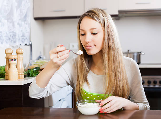istock woman  eating curd cheese in home 511095585
