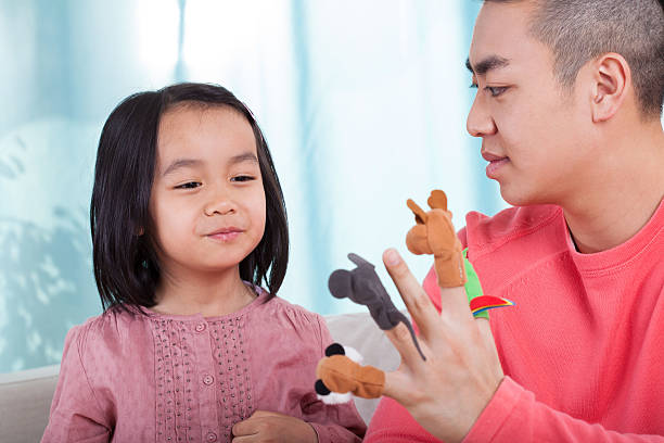 istock Family having fun with hand puppets 511097509
