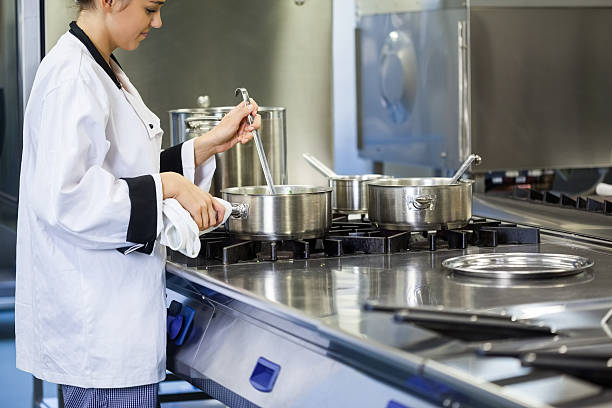 istock Young chef stirring with ladle 511097555