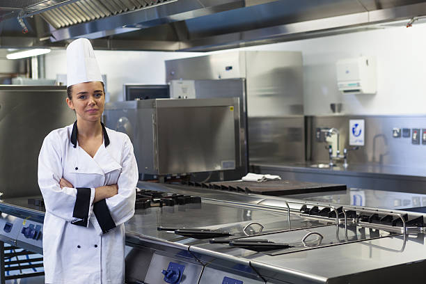 istock Young happy chef standing next to work surface arms crossed 511097687