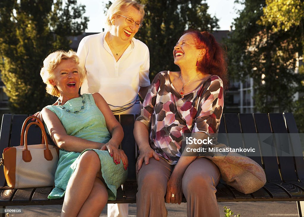 Senior women Three elderly ladies sitting on a bench and have fun Active Seniors Stock Photo