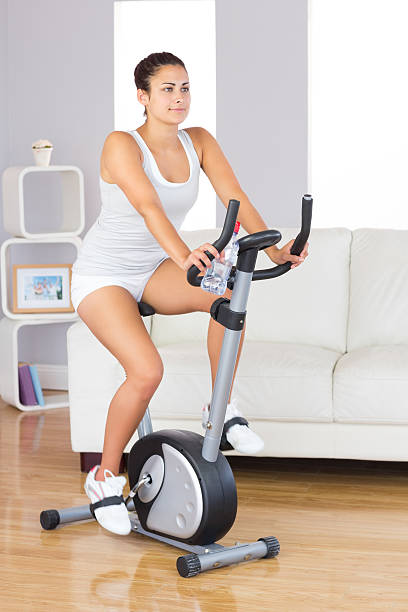 istock Young brunette woman training on an exercise bike 511098497
