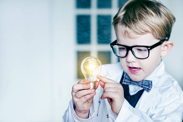 istock Boy scientist gets idea and makes light bulb invention 511099094
