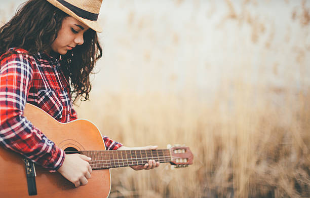 istock young women with guitar 511099612