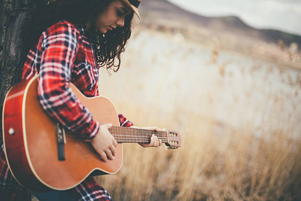 istock young women with guitar 511101196