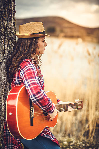 istock young women with guitar 511103480