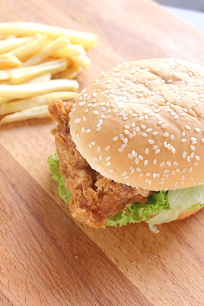 istock Burger and fries on wood background 511107864