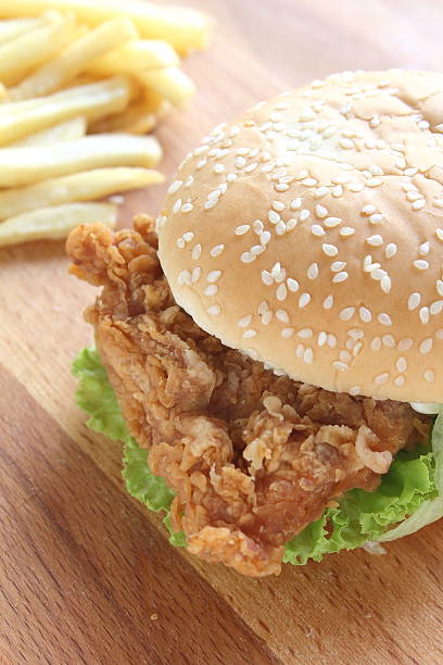 istock Burger and fries on wood background 511108386