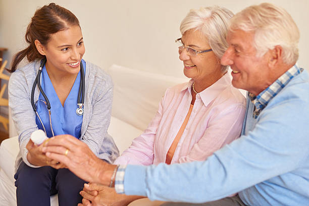 istock Smiling senior couple with their nurse during an appointment 511108766