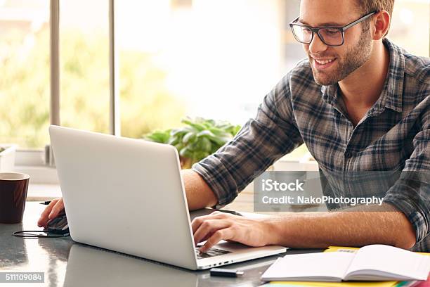 Happy Man Sitting And Working At His Desk From Home Stock Photo - Download Image Now