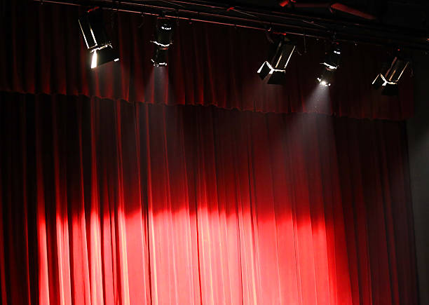 istock red theater curtain over the stage and the lights 511109530