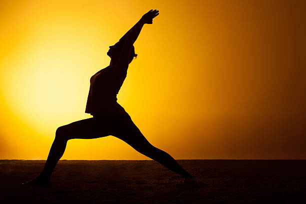 istock The woman practicing yoga in the sunset light 511110556
