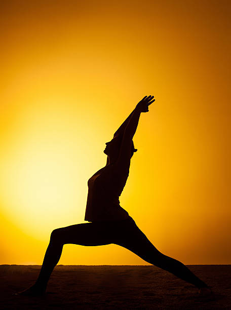 istock The woman practicing yoga in the sunset light 511110634