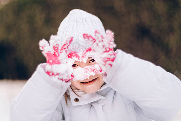 Girl (6-7) Playing in The Snow. Photo of child playing in the snow.