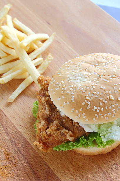 istock Burger and fries on wood background 511111066
