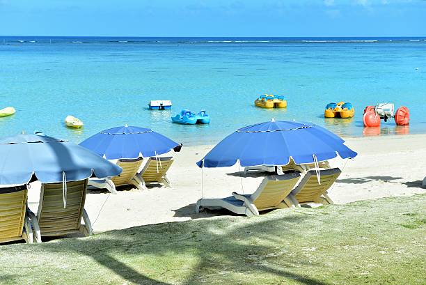 istock Lounge chairs and boats at sandy beach 511111782